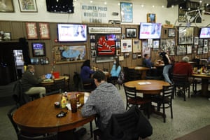 People watch election results come in after the polls closed at Manuel’s Tavern in Atlanta.