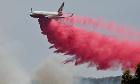 Fire retardant is dropped on an out-of-control bushfire near Taree, New South Wales. The Morrison government has announced it will nearly double to contribution to Australia’s aerial firefighting force. 