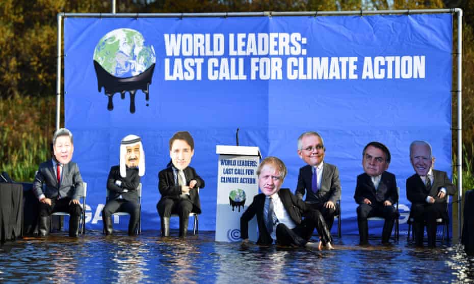 Activists dressed as world leaders protest beside Glasgow’s Forth and Clyde canal against rising water levels during the Cop26 summit