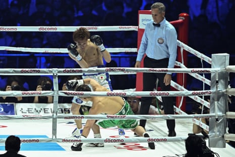 Sho Ishida drops Takuma Inoue to the canvas during the first round of their WBA bantamweight title fight on Monday at the Tokyo Dome.