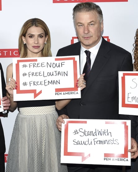 Actor Alec Baldwin and his wife, Hilaria, pose holding signs in support of jailed Saudi women’s rights activists at the 2019 PEN America literary gala in New York
