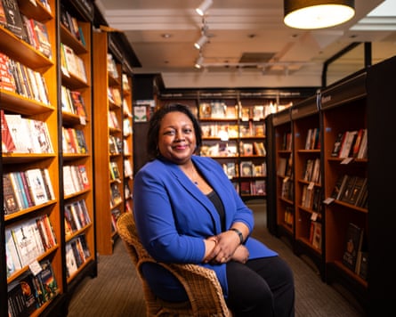 Malorie Blackman in chair surrounded by books