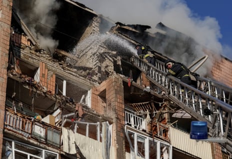 Firefighters work at the site of an apartment building damaged during a Russian drone strike in Kharkiv, Ukraine, on 12 October 2026.