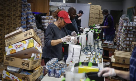 A woman packs free groceries for distribution to the elderly in New Rochelle, New York. 