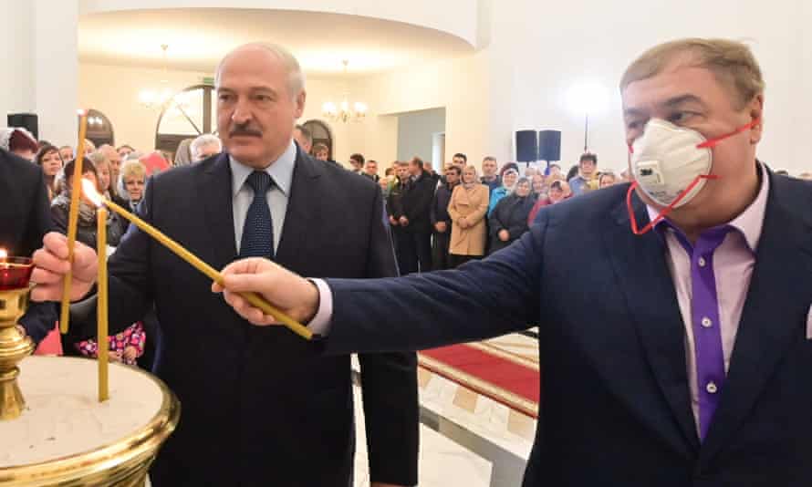 Belarusian President Alexander Lukashenko and Mikhail Gutseriev light candles at a newly built church in the town of Shershuni near Minsk, Belarus.