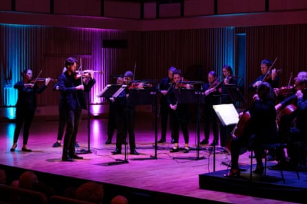 Britten Sinfonia on stage at Saffron Hall under muted blue and purple lighting