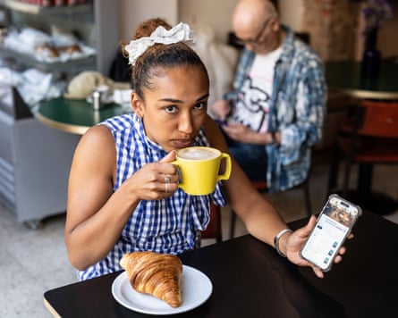 Mabel Banfield-Nwachi uses the Paace app at a cafe in north London.