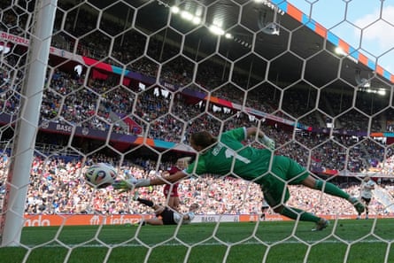 Denmark’s Amalie Vangsgaard squeezes her shot past Germany goalkeeper Ann-Katrin Berger