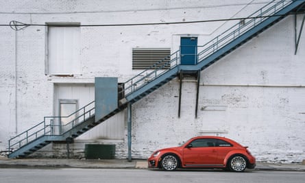 A modified version of the new Beetle parked under a staircase