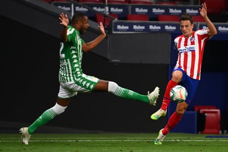 Real Betis’ Sidnei challenges Atletico Madrid’s Colombian defender Santiago Arias.