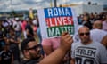 A man holds up a placard saying 'Roma Lives Matter'