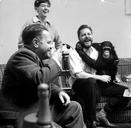 Gerald Durrell holding his pet chimpanzee and talking with his brother, novelist Lawrence Durrell, left, at his home on Jersey in 1961.