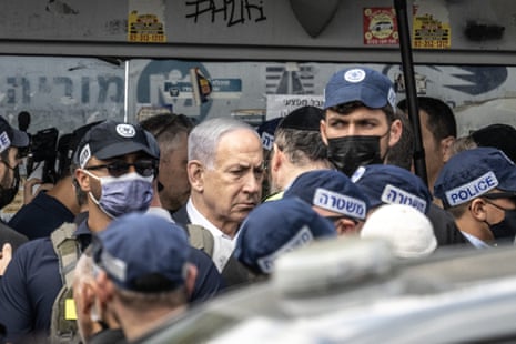 Israeli prime minister Benjamin Netanyahu arrives at the scene after the attack at the Ramot junction on the outskirts of Jerusalem.