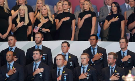 The USA players and their respective wives and girlfriends observe the national anthem during the opening ceremony. 