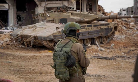 An soldier looks on as Israeli forces operate in the Gaza Strip after the temporary truce with Hamas expired on Friday morning