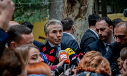Bidzina Ivanishvili surrounded by the press after casting his vote at a polling booth in Tbilisi.