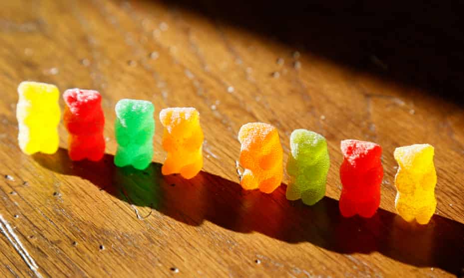 Marijuana-infused sour gummy bear candies, right, are shown next to conventional ones at left in Golden, Colorado in October 2014.