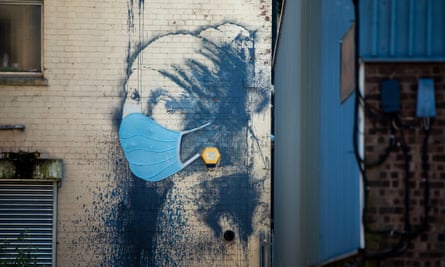Banksy’s The Girl with a Pierced Eardrum in Hanover Place Bristol, with the addition of a medical facemask.