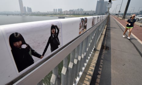 Images are displayed along a bridge in Seoul in an attempt to dissuade potential suicides.