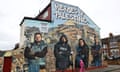 The mural featuring four journalists painted on to the side of a house with the words 'Heroes of Palestine' at the top