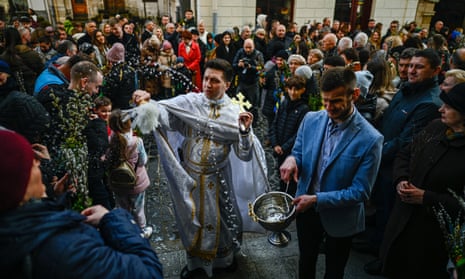 A priest proceeds with the blessing ceremony during the Orthodox Palm Sunday in Lviv, Ukraine .