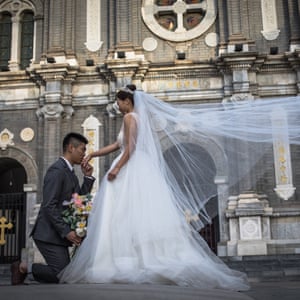 A couple pose for their pre-wedding photos on a street in Beijing