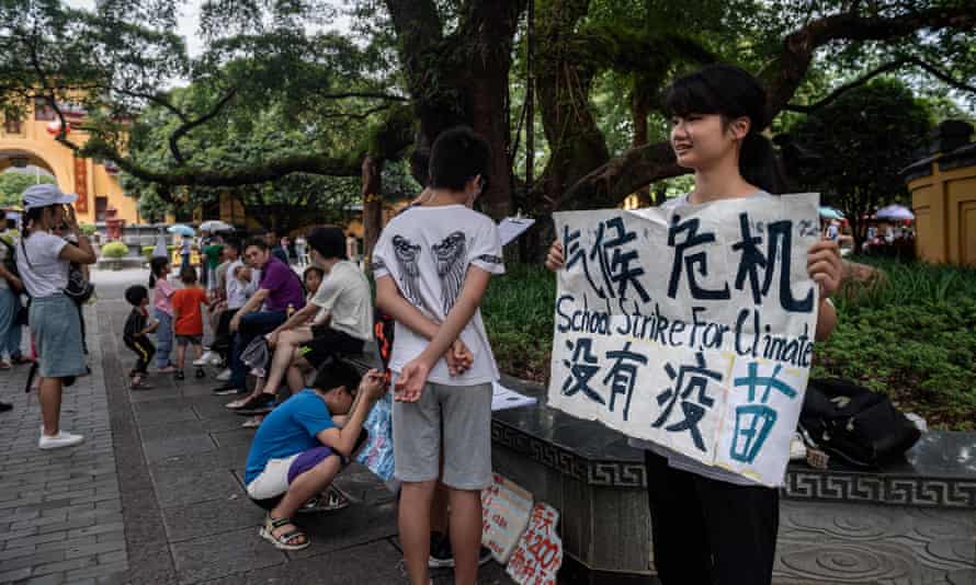 Ou Hongyi, aged 17, stages a protest on a street in Guilin, as the first young person in China to participate in Greta Thunberg-inspired schools climate strikes.