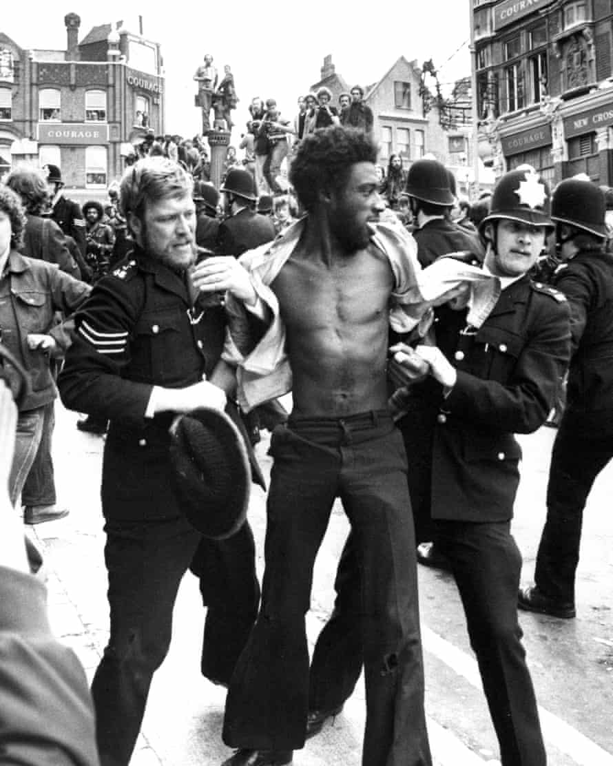 A man is held by police in the Lewisham demonstrations. A total of 214 people were arrested.