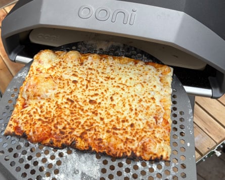 A cooked pizza is taken out of the Koda 2 oven