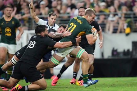 Cameron Hanekom drives through New Zealand tackles.