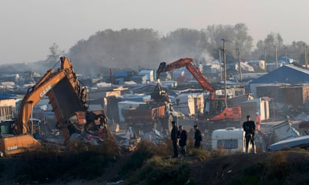Bulldozers are used to tear down makeshift shelters and tents in the camp.