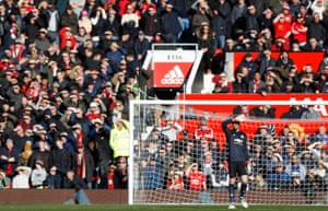 David De Gea and fans shelter their eyes from the sun.