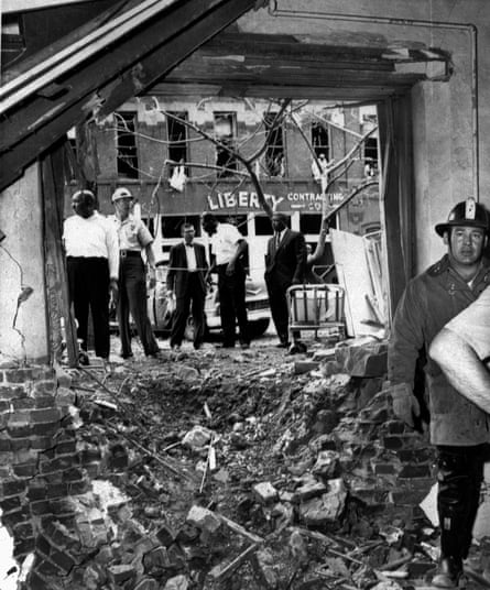 Police and fire crews stand by debris from bomb attack
