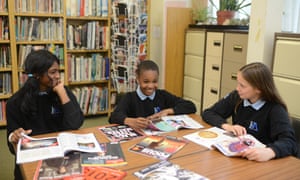 Children in a classroom with newspapers