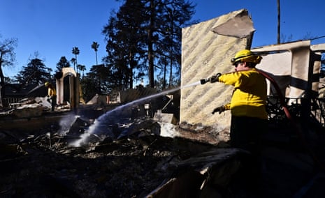 California fires live: LA fire crews make progress as officials expect ‘much-needed break’ from dangerous weather | California wildfires 1 Firefighters hose down rubble