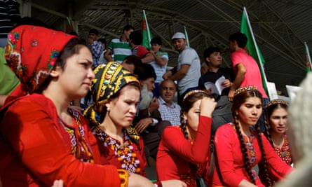 Wearing the traditional twin braids, female university students, dressed in Uzbek clothing, attend the weekly racing event.