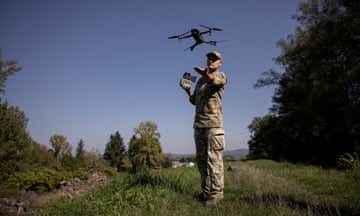 A Ukrainian border guard launches a drone to survey the border with Romania in September 2023.
