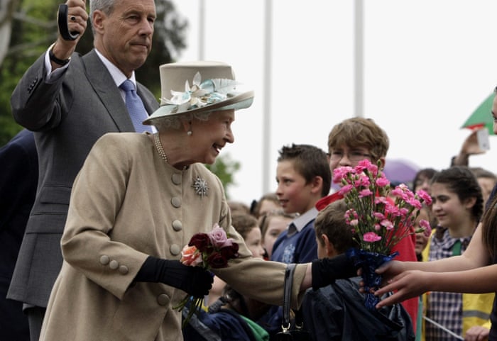 Queen Elizabeth II accepting bouquets of flowers from children outside the Australian War Memorial in Canberra