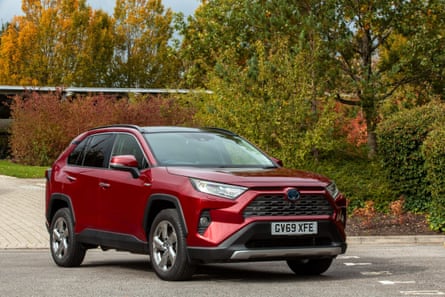 Red Toyota RAV4 Hybrid on the road