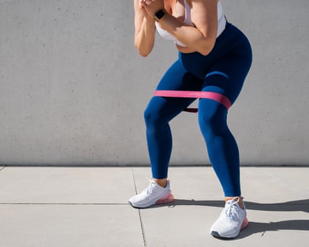 Woman exercising outdoors with resistance band