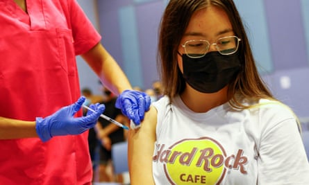 A nurse administers a first jab to a 15-year-old girl at a vaccination centre in Gran Canaria