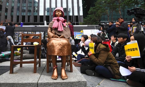 South Korean protesters sit near a statue of a teenage girl symbolising former ‘comfort women’, who served as sex slaves for Japanese soldiers during the second world war