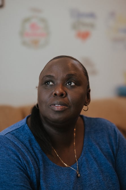a woman in a blue shirt looking up into the distance