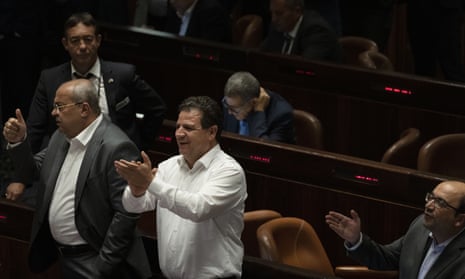 Arab lawmakers celebrate the defeat of a law on the legal status of Jewish settlers in the occupied West Bank, during a session of the Knesset, Israel's parliament, in Jerusalem on Monday.