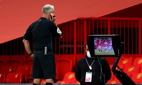 Martin Atkinson consults the monitor before giving a penalty to Crystal Palace for handball by Manchester United’s Victor Lindelöf. 