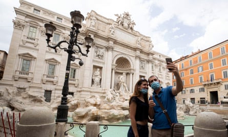 Tourists take a selfie in front of the Trevi Fountain, Rome, on Monday.