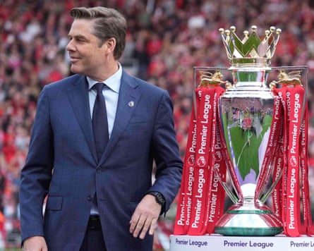 The Premier League’s Richard Masters poses with the trophy