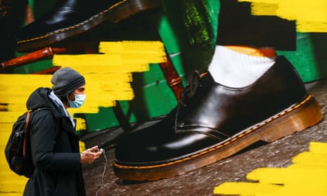 A person walks past the window of a Dr Martens store  in central Madrid during the pandemic