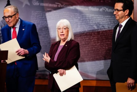 A woman speaks between two men.