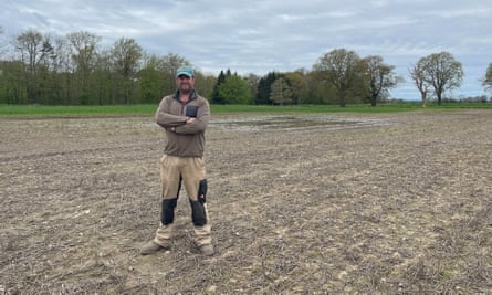 Farmer Rory Lay standing in a wet field.